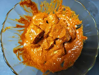 Marinated tandoori soya chaap with red tandoori masala in a bowl