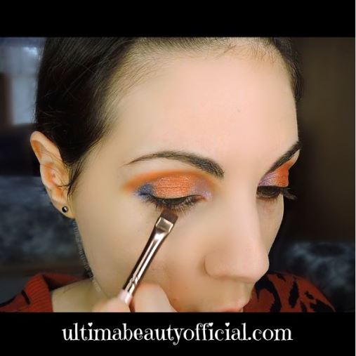 Ultima Beauty applying Bitter Half to lower lash line with a brush