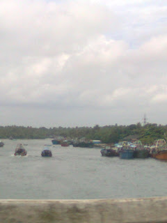 these pictures are taken on Nokia Mobile while traveling from changanassery kottayam kerala to alappuzha on a rainy day- find coconut trees on paddy fields, small water passing along with road, house boats parking and resting at nedumudy alappuzha, famous also for nedumudi venu, a great actor in Malayalam film industry and some pictures are taken at thoppumpady ernakulam where fishing boats parking