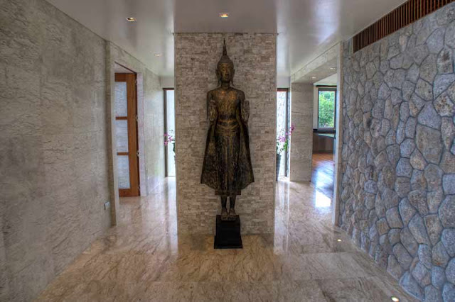 Statue and stone wall in the hallway of Villa Liberty, Phuket
