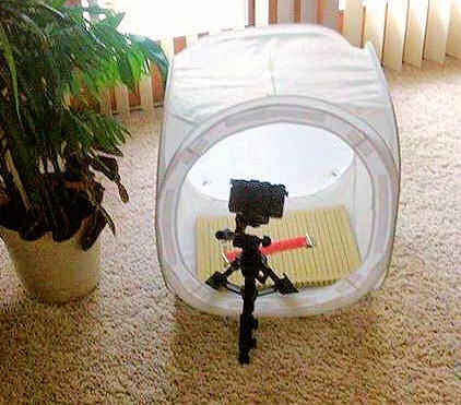Camera on tripod with light box.