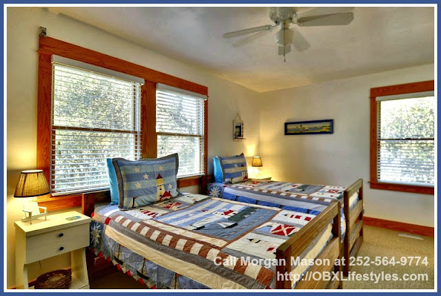 The colorful decor of this Outer Banks NC home for sale's bedroom reminds you that you are waterside on the Currituck Sound. 
