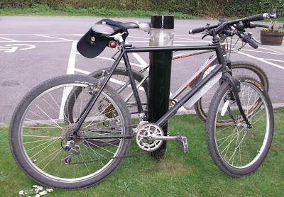 2 Mountain bikes leaning against a post