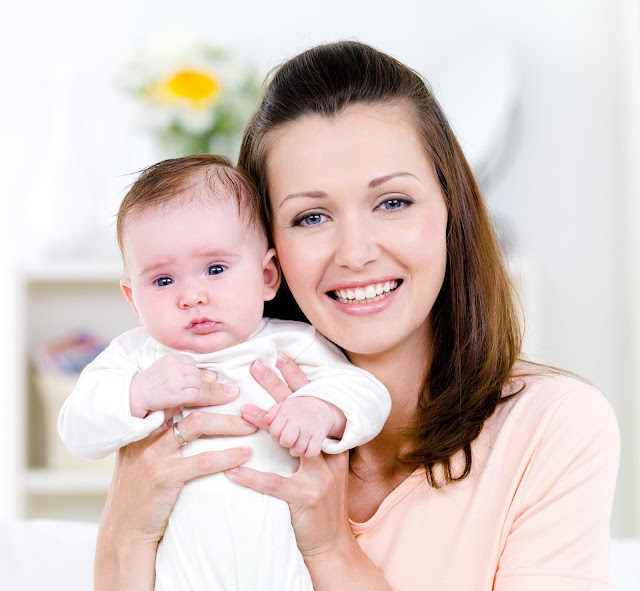 Smiling woman with baby