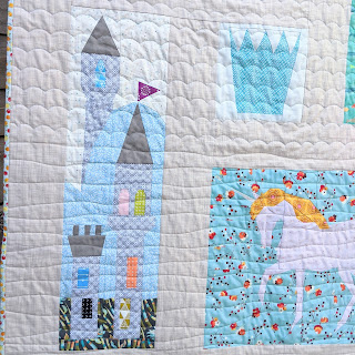 fairytale quilt blocks of a castle, crown and unicorn that are part of the quilt 