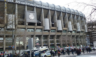 Vista parcial exterior del edificio, todo hormigón, con el escudo del club y numeroso público momentos antes de un partido.