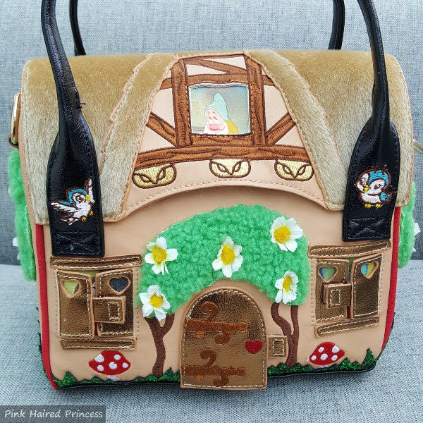 front of handbag shaped like woodland cottage