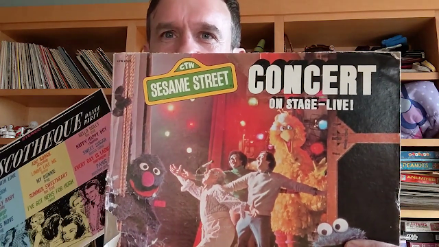 picture of man holding record album