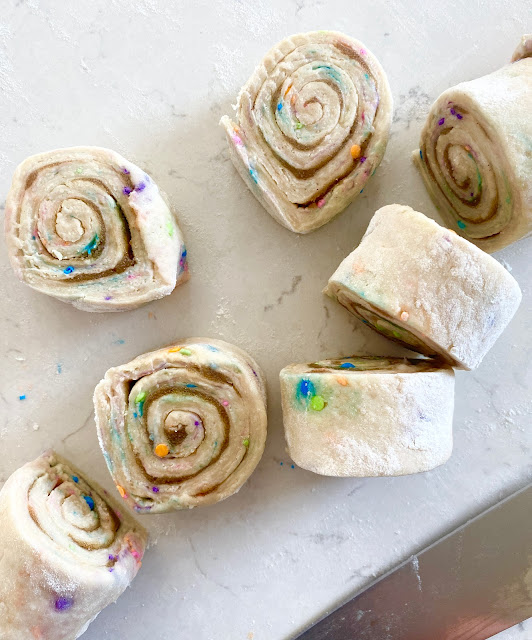 Easter cinnamon rolls cut on a cutting board.