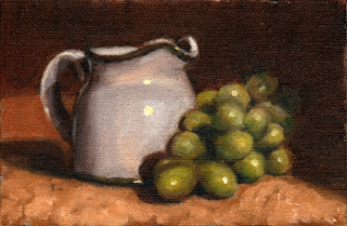 Oil painting of a white porcelain milk jug beside a bunch of green plastic grapes.