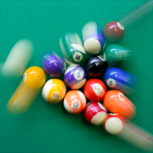 Momentum of a pool cue ball is transferred to the racked balls after collision. Wikipedia, 2023.