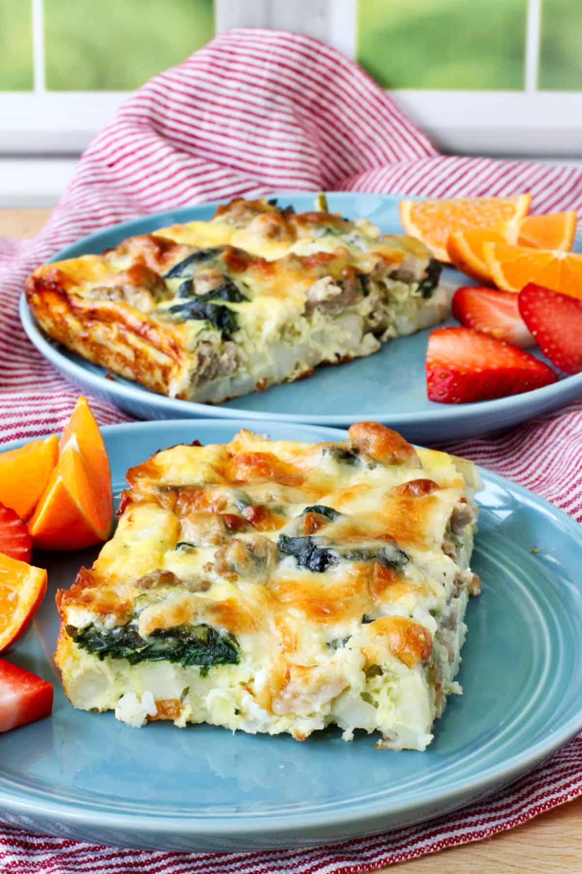 Sausage and Spinach Breakfast Casserole on blue plates.