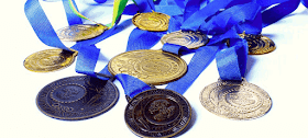 A variety of medals on blue ribbons lying in a pile, representing the concept of rewards, which is how many players perceive experience points.