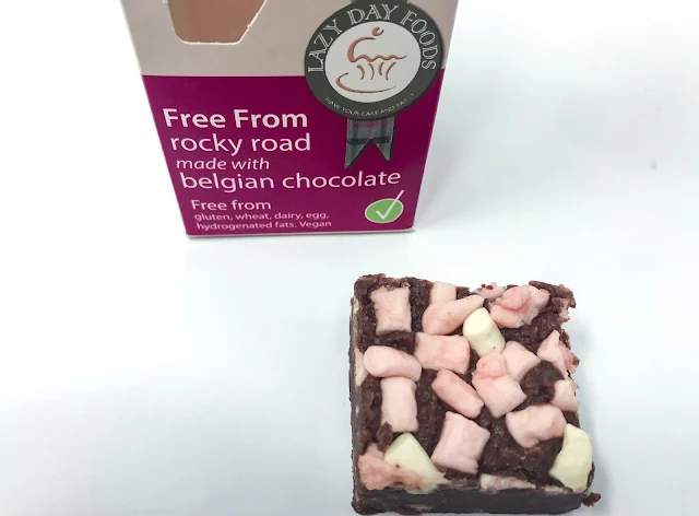 Lazy Food Days Free From rocky road box next to a piece of Rocky Road covered in mini vegan marshmallows