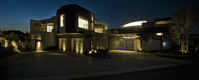 Modern home at night from the street