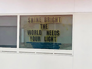 A hospital window that says, "Shine bright.  The world needs your light."