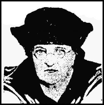 Photo clipped from newspaper, showing middle-aged woman in wire rim spectacles