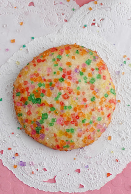 sugar cookie on white and pink background from above.