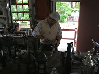 Colonial Williamsburg Man making items out of tin