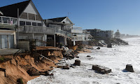 June 2016’s devastating storms damaged beachfront homes on Sydney’s northern beaches. Some are calling for a seawall to be put in place. (Photograph Credit: Dean Lewins/AAP) Click to Enlarge.