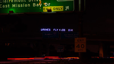 "DRONES FLY KIDS DIE" - Overpass Light Brigade