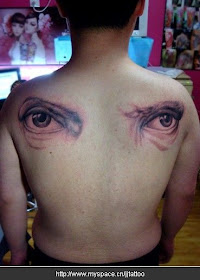 complimentary tattoo design with two eyes inked on two sides of the shoulder