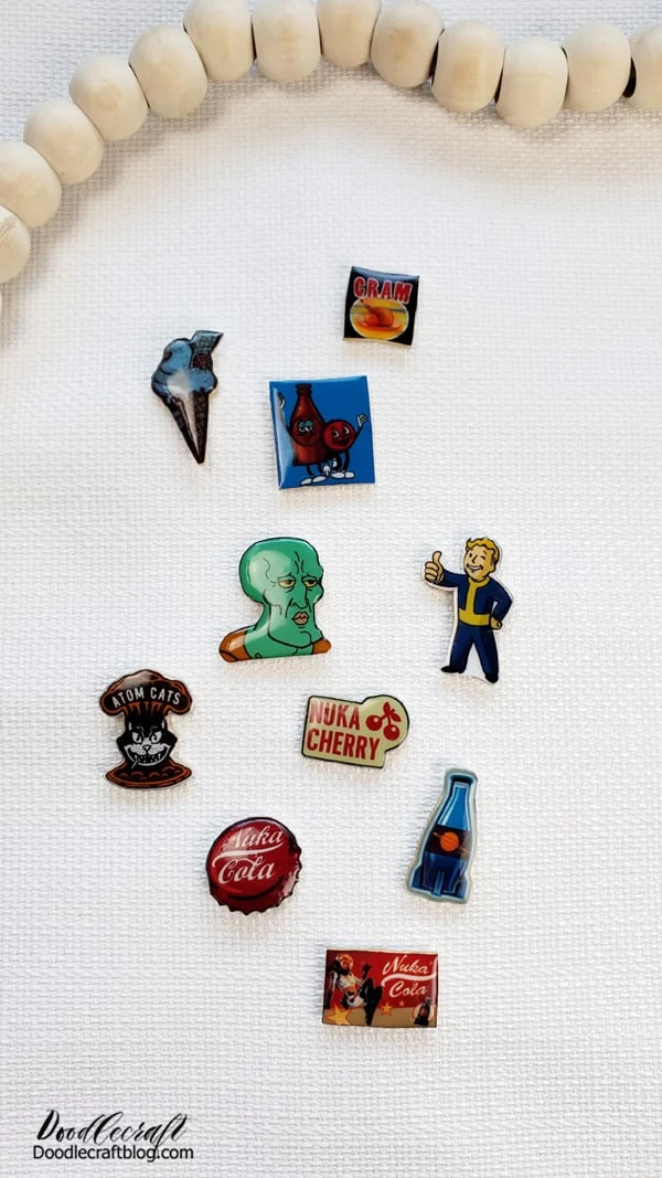 Learn how to make your own enamel pins with this fun faux shrink plastic enamel pin technique!   Make a collection of full color pin badges in various shapes.   I'll show you how to make them every step of the way!