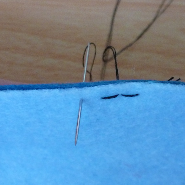 working backstitch along edge of fabric for hand sewing