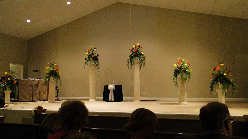 The flower arrangements were removed and carried to the reception area after