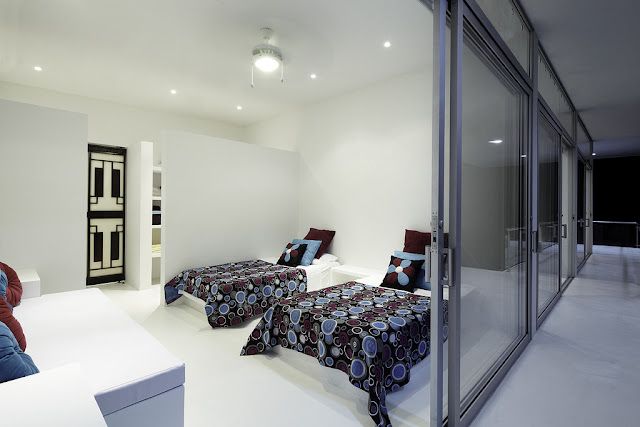 White modern bedroom with two single beds 