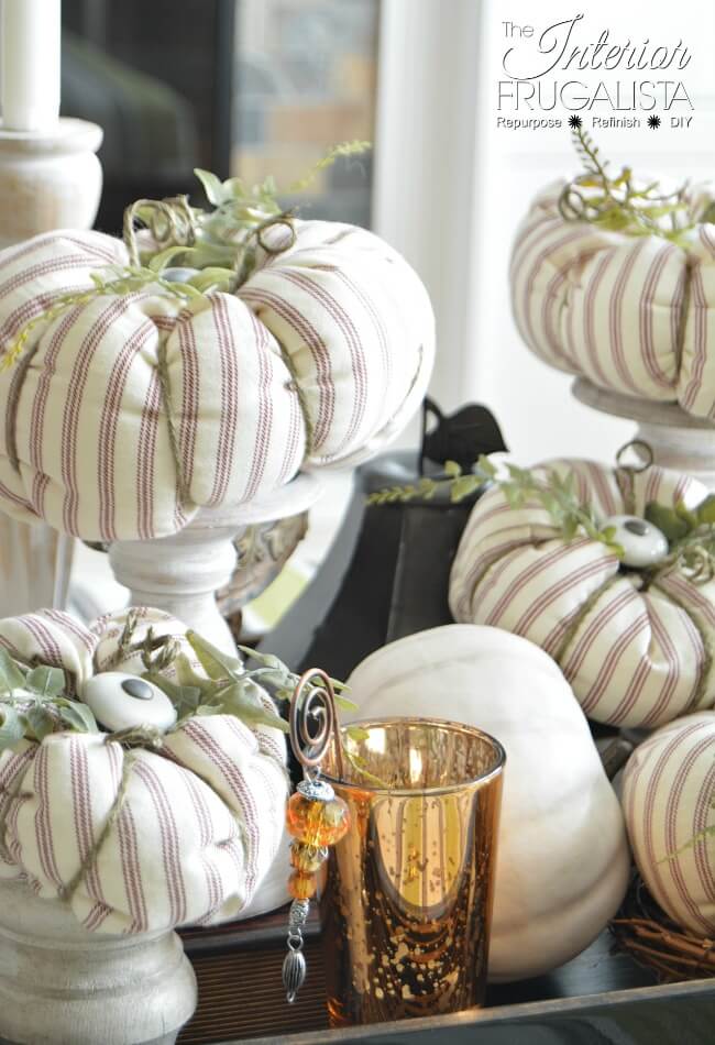 Here I show you how to salvage an old ticking stripe slipcover and kitchen cabinet knobs into pretty fabric pumpkins with farmhouse style for fall.