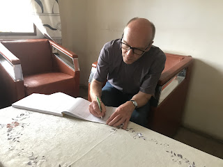 Pastor Karsten Schneider signing in a guest book