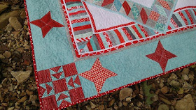 Red and aqua string star round robin quilt