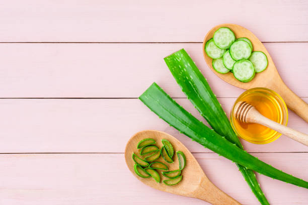 Aloe vera, cucumber, honey, wooden spoon. Skincare and beauty spa concept.