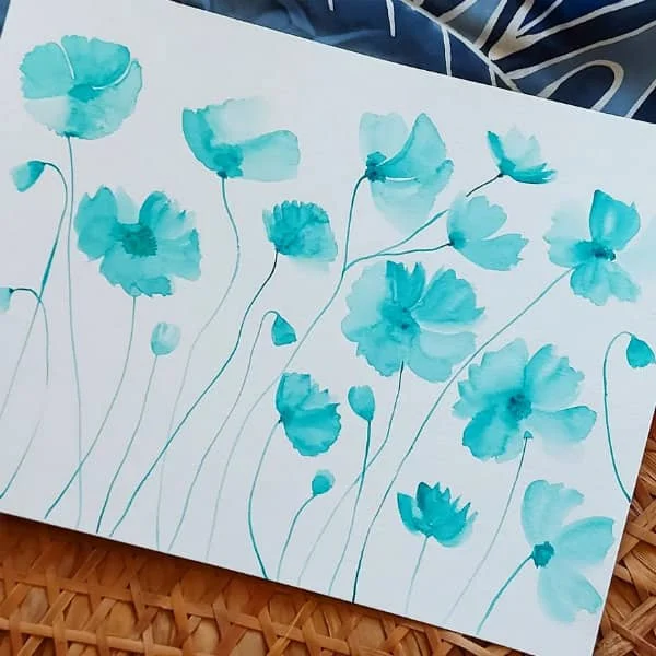 aqua watercolor flowers on white paper