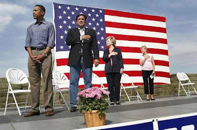 Barack Hussein Obama refuses to place his hand over his heart to pledge allegiance to the United States of America.  See the original photo in Time Magazine.  Check it out on Snopes.  It's true.