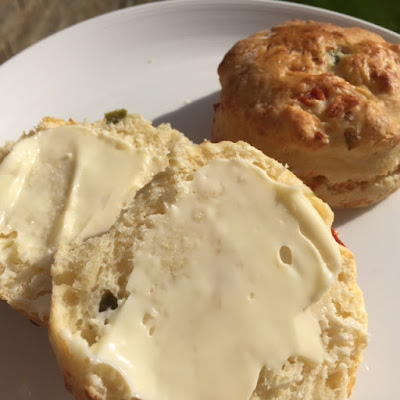 Cheese and Jalapeno Scone buttered on a white plate