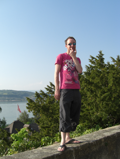 Standing on the wall viewing Lake Murten on Road trip through Swtizerland