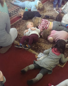 toddlers lying on floor at Tots Club. shhh