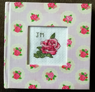 Cross stitched rose on a book