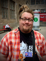 Jukka standing before Kaapelitehdas at Finncon 2013 wearing a leopard fez