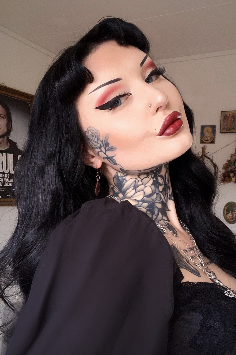 close-up portrait of a young, beautiful woman with goth eyeliner makeup look