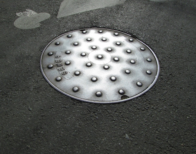 manhole cover in sun