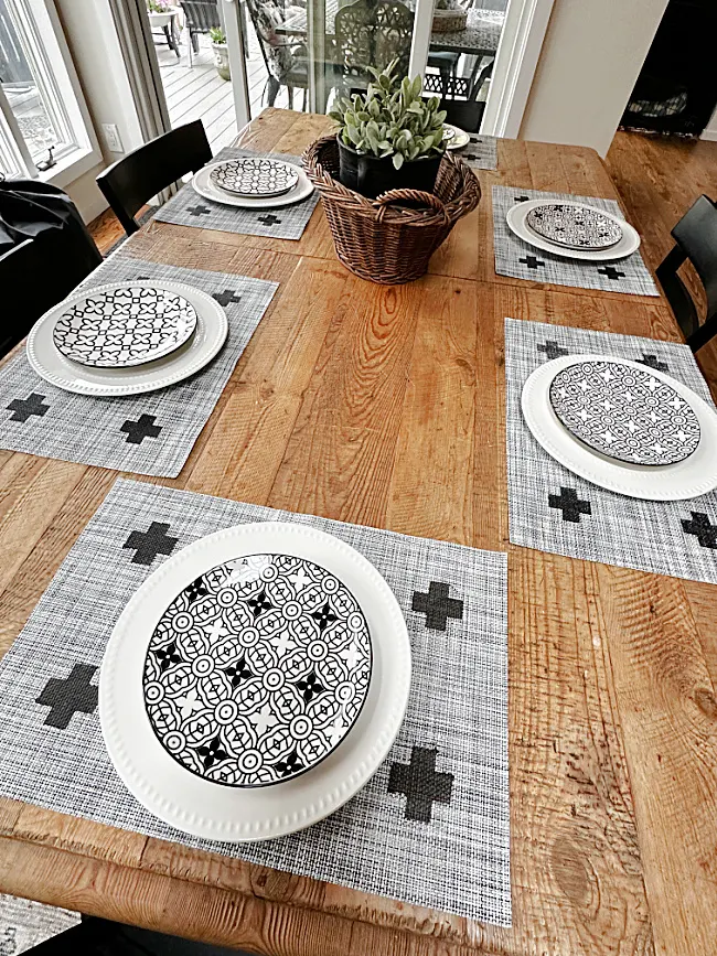 table set with cross placemats and dishes