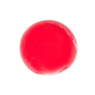 A circular pool of bright red lip oil on a bright background