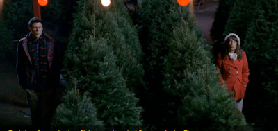 Finn and Rachel singing in a Christmas tree lot