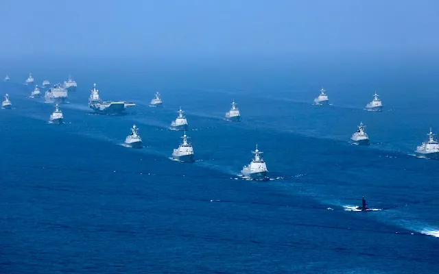 The Liaoning aircraft carrier is accompanied by navy frigates and submarines conducting an exercises in the South China Sea