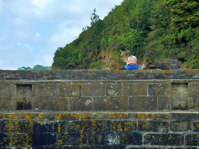 Girl on sea wall at Charlestown Harbour, Cornwall