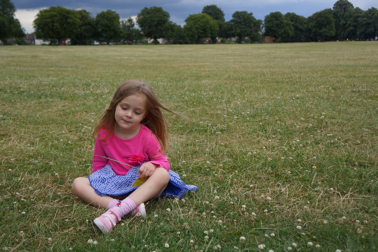 girl sitting on grass in park