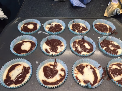 Brownie and cheesecake batter in the cupcake cases.